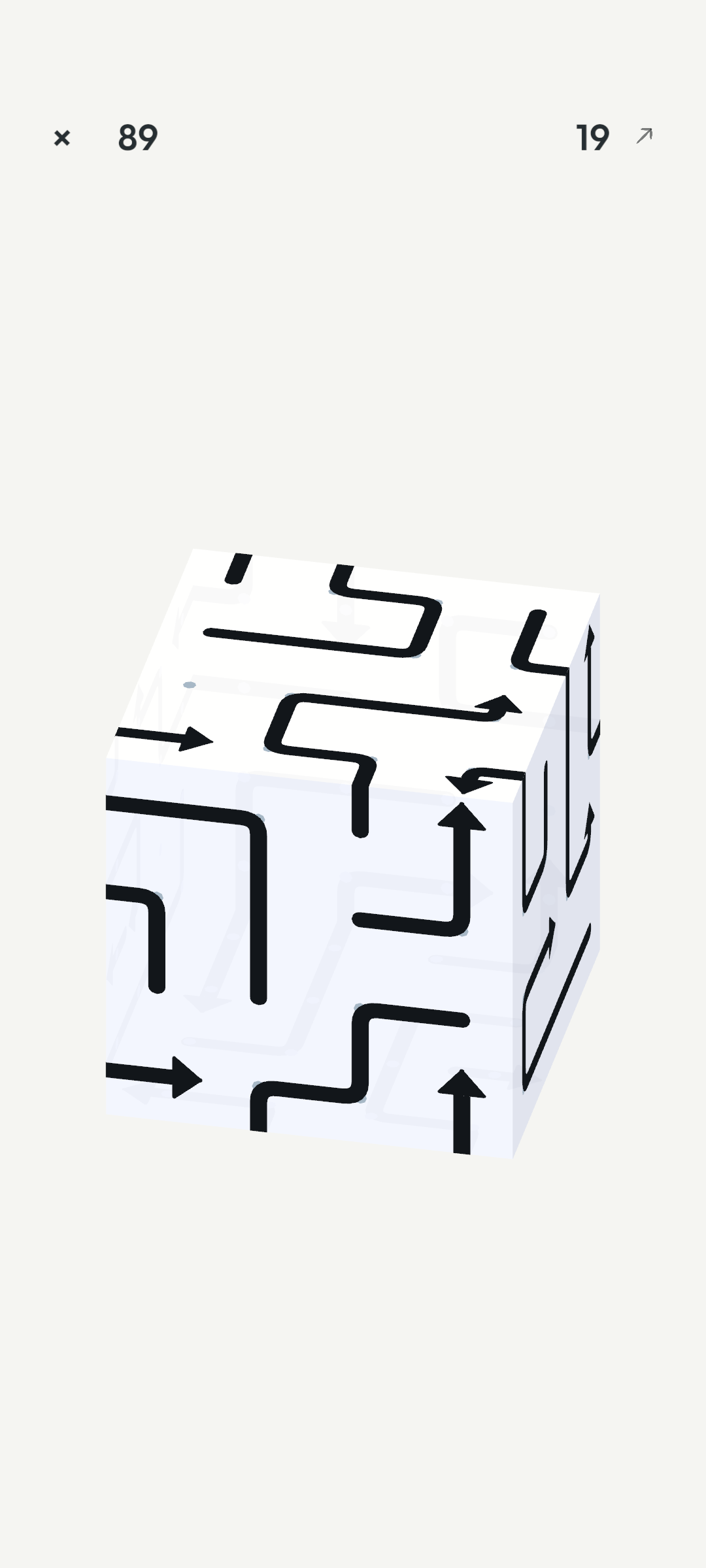 A real JunBan puzzle: rounded black arrow paths wrapping across a translucent white cube